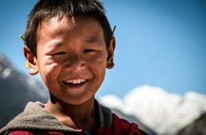 A Tibetan boy, son of the Plantation Caretaker, at the apple tre